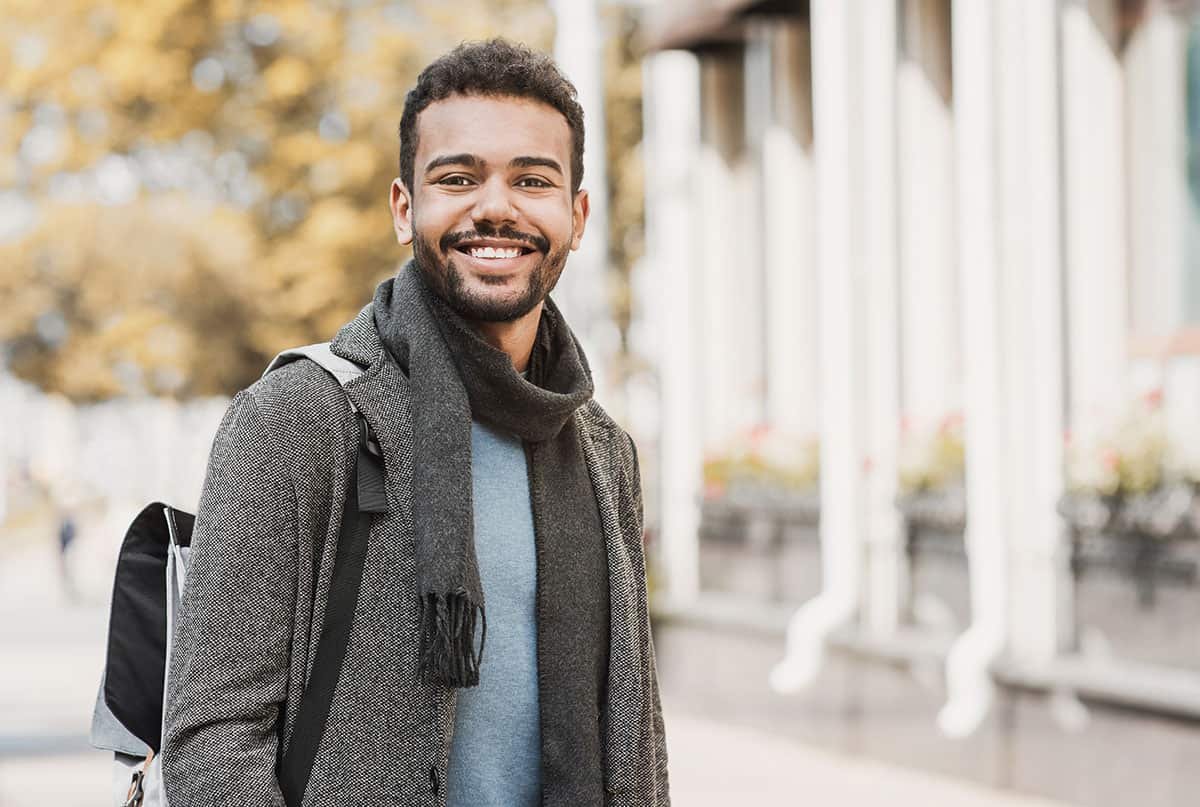 man smiling outside knowing what is sober living