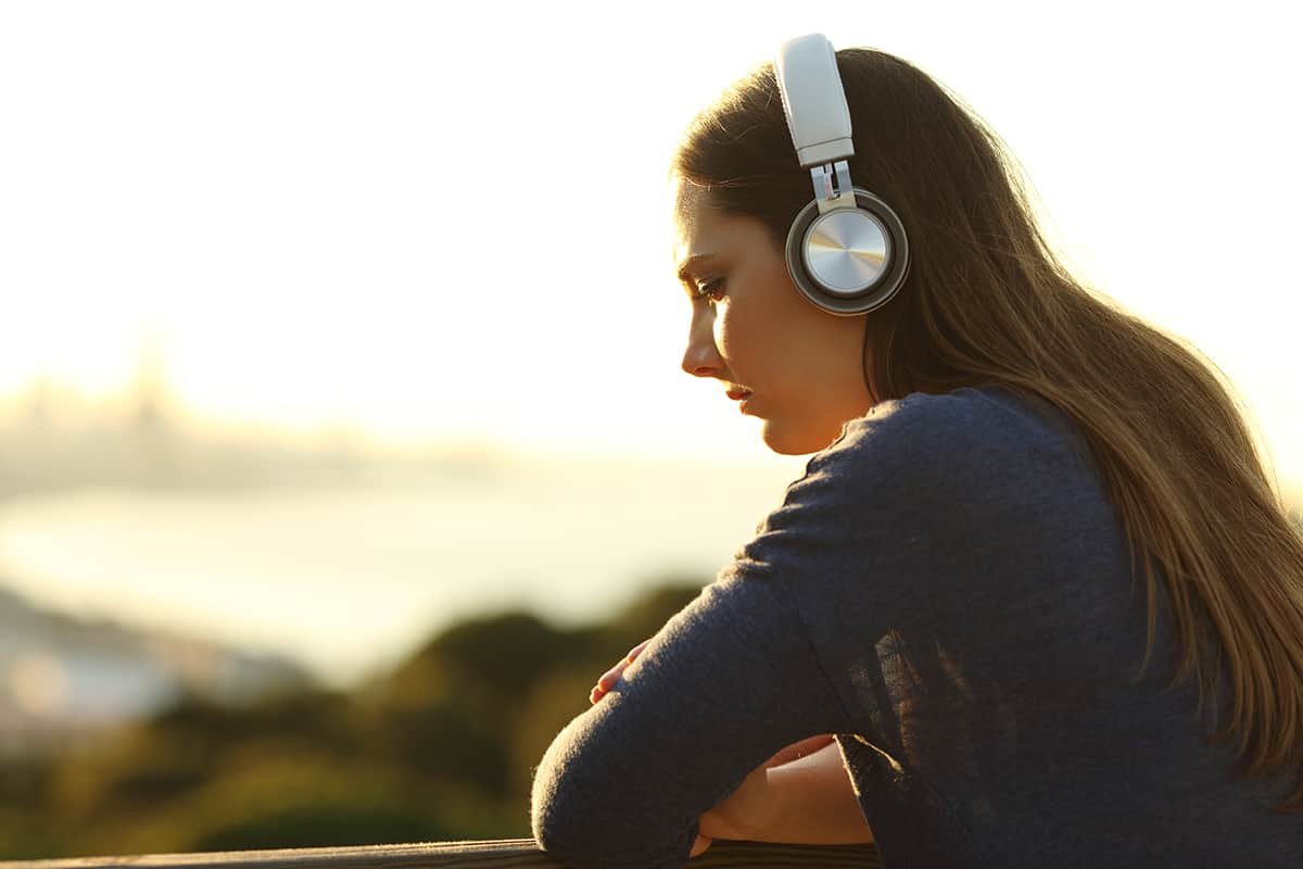 woman with headphones dealing with stress management and addiction recovery