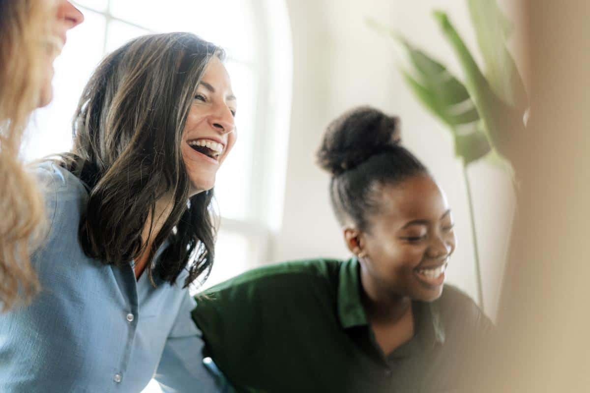 women laughing together in sober living for women
